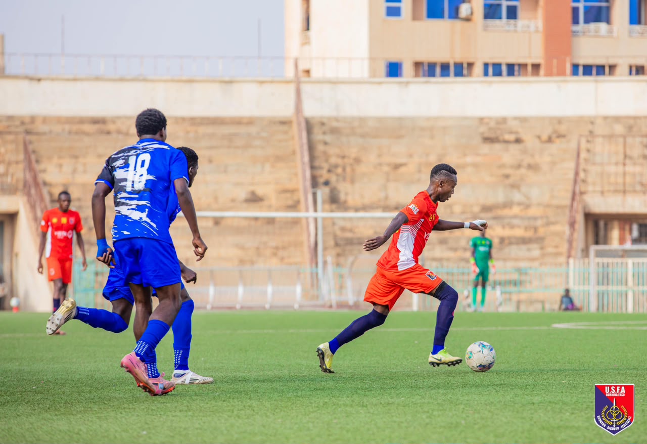Sanou driving forward with the ball during a match