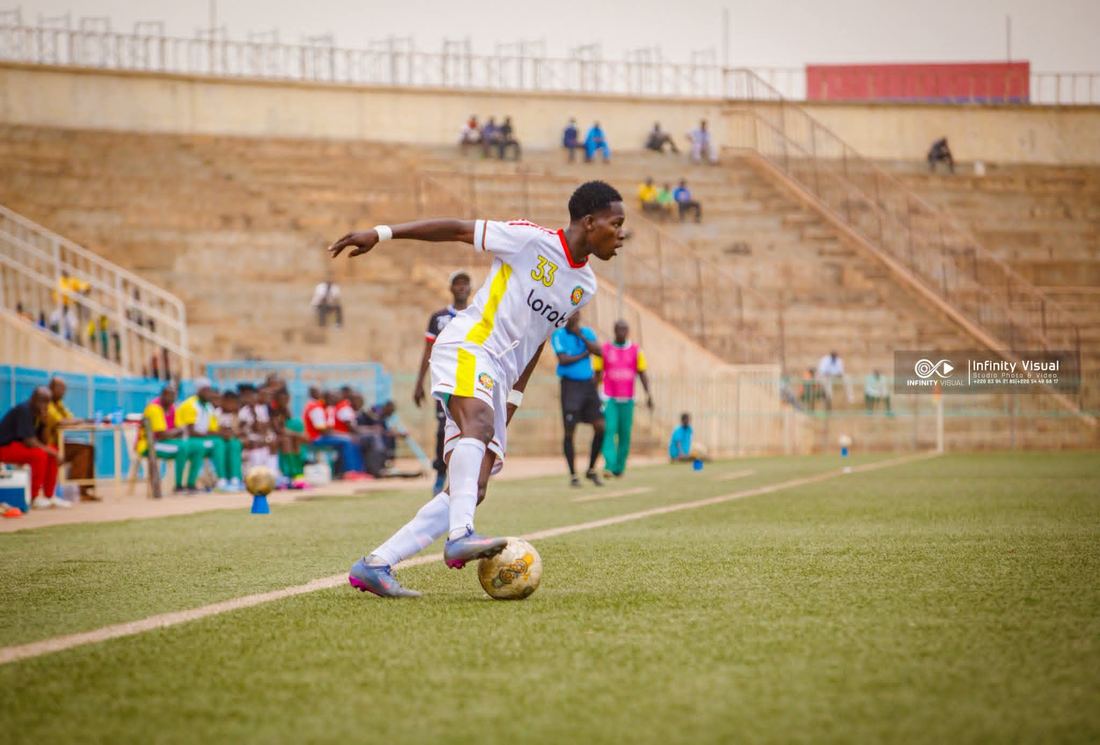 Yerbanga carrying the ball past a defender